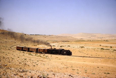 Hedjaz Jordan Railway 4-6-2 steam locomotive no. 82 pulling passenger cars in the desert near Amman, Jordan, on July 16, 1991. Photograph by Fred M. Springer, © 2014, Center for Railroad Photography and Art.  Springer-Hedjaz-ZimZam(1)-04-31