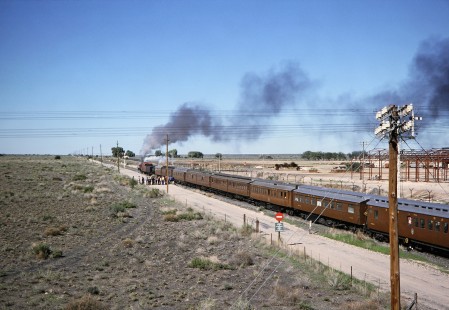 South African Railway 4-8-4 steam locomotive no. 3417 moves down the track with a train of passenger cars as a small crowd of people gathers on the road in De Aar, Northern Cape, South Africa, on April 1, 1995. Photograph by Fred M. Springer, © 2014, Center for Railroad Photography and Art. Springer-So.Africa-NOR-SWE-04-19