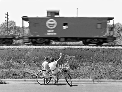 Two youngsters wave at southbound Missouri Pacific Railroad train approaching downtown Austin, Texas, in April 1964. Photograph by J. Parker Lamb, © 2016, Center for Railroad Photography and Art. Lamb-02-061-06