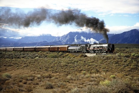 South African Railway 4-8-4 steam locomotive no. 3501 moves across the vast landscape with a passenger train in Western Cape, South Africa, on March 19, 1995. Photograph by Fred M. Springer, © 2014, Center for Railroad Photography and Art. Springer-So.Africa(1)-10-11