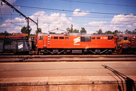 South African Railway "Blue Train" (formerly Spoornet) electric locomotive no. E-1237 waits at Klerksdorp, North West, South Africa, on March 17, 1995. Photograph by Fred M. Springer, © 2014, Center for Railroad Photography and Art. Springer-So.Africa(1)-07-07