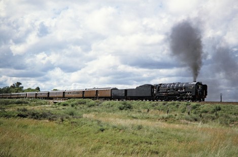 South African Railway 4-8-4 steam locomotive no. 3410 or "Paula" travels with a 10-car passenger train in Hertzberg, Free State, South Africa, on March 30, 1995. Photograph by Fred M. Springer, © 2014, Center for Railroad Photography and Art. Springer-So.Africa-NOR-SWE-01-27