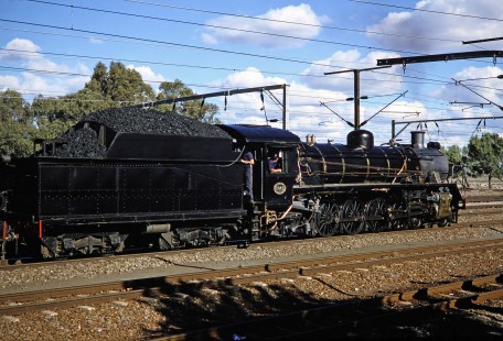 South African Railway 4-8-2 steam locomotive no. 2649 or "Anna" waits as rail workers talk together in Springfontein, Free State, South Africa, on March 30, 1995. Photograph by Fred M. Springer, © 2014, Center for Railroad Photography and Art. Springer-So.Africa-NOR-SWE-01-16