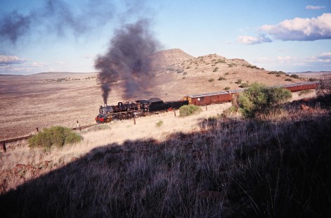 South African Railway 4-8-2 steam locomotive no. 2649 or "Anna" traveling along the hilly track in Springfontein, Free State, South Africa, on March 30, 1995. Photograph by Fred M. Springer, © 2014, Center for Railroad Photography and Art. Springer-So.Africa-NOR-SWE-01-08