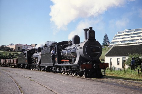 South African Railway 4-8-0 steam locomotives nos. 1007 and 1056 travel into Mossel Bay, Western Cape, South Africa, on March 21, 1995. Photograph by Fred M. Springer, © 2014, Center for Railroad Photography and Art. Springer-So.Africa(1)-12-03