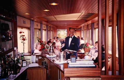 A server of the South African Railway Blue Train lounge car attends to various train passengers in Johannesburg, Gauteng, South Africa, on March 17, 1995. Photograph by Fred M. Springer, © 2014, Center for Railroad Photography and Art. Springer-So.Africa(1)-07-20