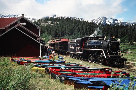 Onlookers are presented with two forms of transport with the kayaks and White Pass and Yukon Route steam locomotive no. 73 as it approaches the station in Bennett, British Columbia, Canada, on June 13, 1998. Photograph by Fred M. Springer, © 2014, Center for Railroad Photography and Art. Springer-Alaska-NZ-11-32