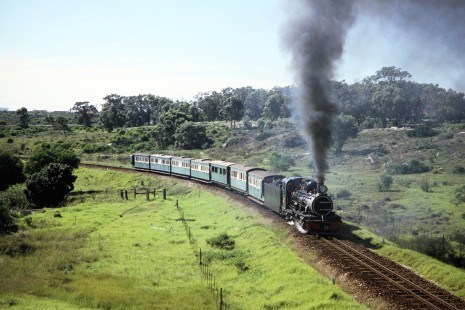 Avontuur Railway steam locomotive no. 145 rounds a small curve in the country track in Port Elizabeth, Eastern Cape, South Africa, on March 25, 1995. Photograph by Fred M. Springer, © 2014, Center for Railroad Photography and Art. Springer-So.Africa(1)-19-37