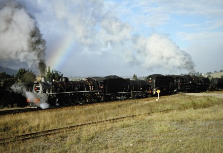 South African Railway steam locomotives nos. 2683 and 4122 with a rainbow in Camfer, Western Cape, South Africa, on March 23, 1995. Photograph by Fred M. Springer, © 2014, Center for Railroad Photography and Art. Springer-So.Africa(1)-17-39