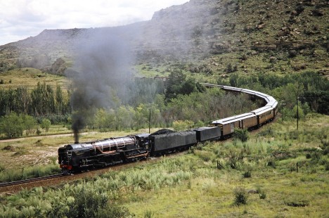 South African Railway 4-8-4 steam locomotive no. 3410 takes on a sharp curve in the track in Clocolan, Free State, South Africa, on March 26, 1995. Photograph by Fred M. Springer, © 2014, Center for Railroad Photography and Art. Springer-So.Africa(1)-21-24