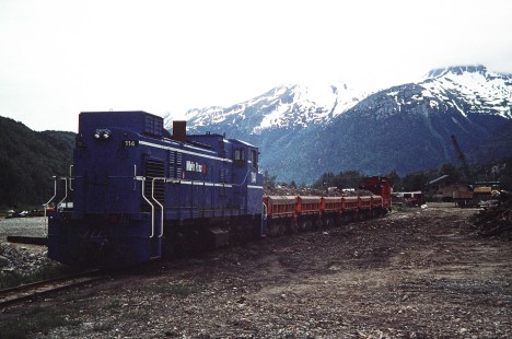 White Pass and Yukon Route blue diesel locomotive no. 114 carries seven-car work train of rocks in Skagway, Alaska, United States, on June 14, 1998. Photograph by Fred M. Springer, © 2014, Center for Railroad Photography and Art. Springer-Alaska-NZ-12-10
