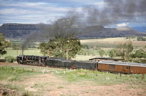 South African Railway 4-8-4 steam locomotive no. 3410 moves down the open country track in Clocolan, Free State, South Africa, on March 26, 1995. Photograph by Fred M. Springer, © 2014, Center for Railroad Photography and Art. Springer-So.Africa(1)-21-19
