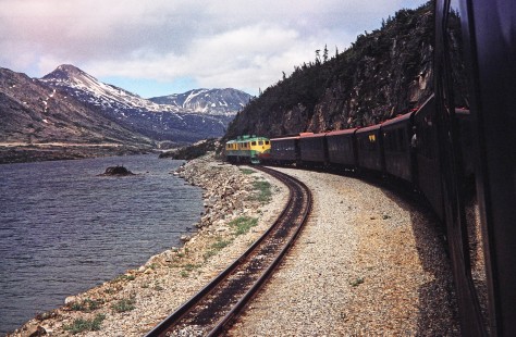 White Pass and Yukon Route diesel locomotives lead a passenger train along a lake in Fraser, British Columbia, Canada, on June 11, 1998. Photograph by Fred M. Springer, © 2014, Center for Railroad Photography and Art. Springer-Alaska-NZ-06-16
