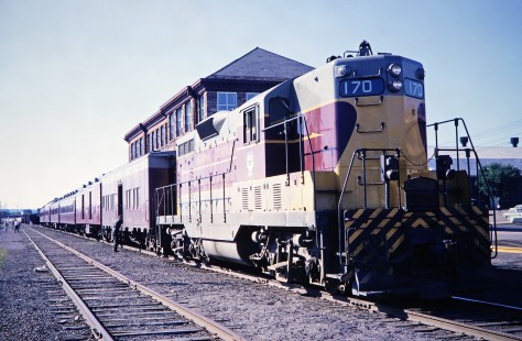 Algoma Central Railway diesel locomotive no. 170 sits before a station in Sault St. Marie, Ontario, Canada, as part of the Agawa Canyon Tour Train, on July 4, 1966. Photograph by Fred M. Springer, © 2014, Center for Railroad Photography and Art. Springer-East2-22-12