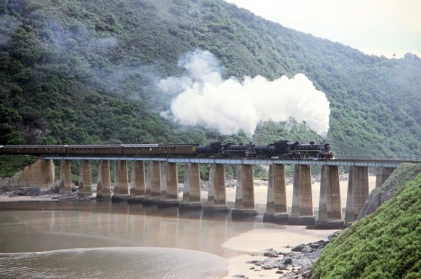 South African Railway steam locomotives carry a train of passenger cars over the Kaaimans River in George, Western Cape, South Africa, on March 22, 1995. Photograph by Fred M. Springer, © 2014, Center for Railroad Photography and Art. Springer-So.Africa(1)-15-25