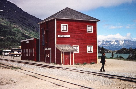 A White Pass & Yukon Railroad conductor walks across the tracks in front of the Fraser station in Fraser, British Columbia, Canada, on June 12, 1998. Photograph by Fred M. Springer, © 2014, Center for Railroad Photography and Art. Springer-Alaska-NZ-09-28