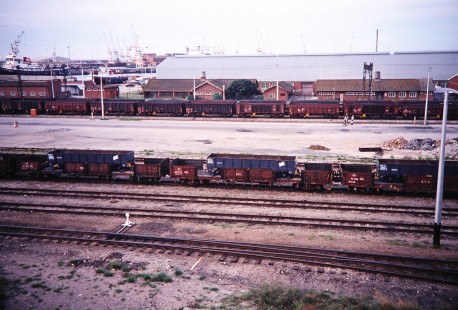 An assortment of freight cars wait on the tracks in a railroad yard in Port Elizabeth, Eastern Cape, South Africa, on March 25, 1995. Photograph by Fred M. Springer, © 2014, Center for Railroad Photography and Art. Springer-So.Africa(1)-20-19