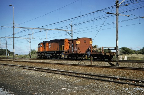 South African Railway (formerly Spoornet) locomotive no. 35 carries three men to Kroonstad/Hennenman, Free State, South Africa, on March 30, 1995. Photograph by Fred M. Springer, © 2014, Center for Railroad Photography and Art. Springer-So.Africa(1)-24-03