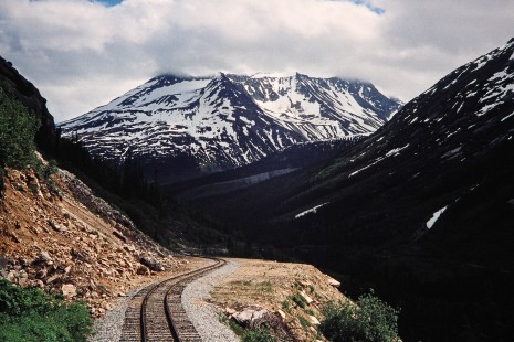 Snow-capped mountain view along the White Pass & Yukon Railroad in Fraser, British Columbia, Canada, on June 11, 1998. Photograph by Fred M. Springer, © 2014, Center for Railroad Photography and Art. Springer-Alaska-NZ-06-32