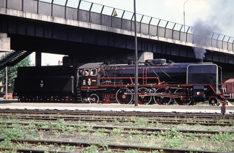 Polskie Koleje Państwowe (Polish State Railways) 2-8-2 steam locomotive no. Pt47-65 travels under a bridge in Wolsztyn, Greater Poland, Poland, on May 21, 1993. Photograph by Fred M. Springer, © 2014, Center for Railroad Photography and Art. Springer-Europe-03-07