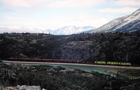 A White Pass and Yukon Route train with three diesel locomotives and eight cars move over the natural landscape near Fraser, British Columbia, Canada, on June 12, 1998. Photograph by Fred M. Springer, © 2014, Center for Railroad Photography and Art. Springer-Alaska-NZ-09-14