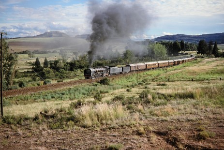 A landscape shot of South African Railway 4-8-4 steam locomotive no. 3410 in Clocolan, Free State, South Africa, on March 26, 1995. Photograph by Fred M. Springer, © 2014, Center for Railroad Photography and Art. Springer-So.Africa(1)-21-21