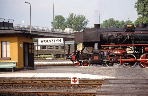 A Polskie Koleje Państwowe (Polish State Railways) steam locomotive pulls into Wolsztyn station parallel to a nearby passenger car in Wolsztyn, Greater Poland, Poland, on May 20, 1993. Photograph by Fred M. Springer, © 2014, Center for Railroad Photography and Art. Springer-Europe-01-11