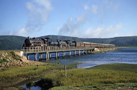 South African Railway steam locomotives cross the Knysna Lagoon in Knysna, Western Cape, South Africa, on March 22, 1995. Photograph by Fred M. Springer, © 2014, Center for Railroad Photography and Art. Springer-So.Africa(1)-15-02
