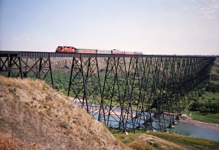 Canadian Pacific Railway diesel locomotive pulls a five-car passenger train over the Lethbridge Viaduct to cross the Oldman River in Lethbridge, Alberta, Canada, on July 8, 2003. Photograph by Fred M. Springer, © 2014, Center for Railroad Photography and Art. Springer-Canada-NZ(1)-03-13