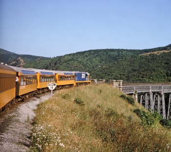 Taieri Gorge Train diesel locomotive no. 3211 pulls a passenger train toward the Wingatui Viaduct in Dunedin, Otago, New Zealand, on January 19, 1994. Photograph by Fred M. Springer, © 2014, Center for Railroad Photography and Art. Springer-NZ(1)-16-08