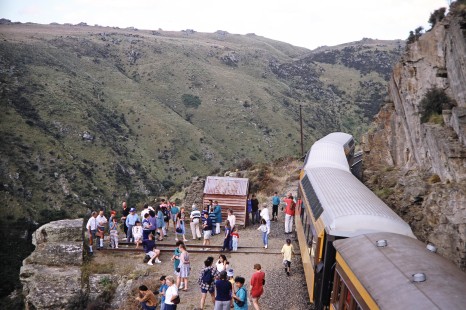 Passengers get off a Taieri Gorge Railway passenger train to see and photograph the cliffs in Dunedin, Otago, New Zealand, on January 19, 1994. Photograph by Fred M. Springer, © 2014, Center for Railroad Photography and Art. Springer-NZ(1)-16-11