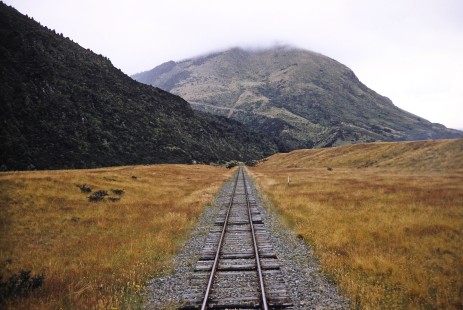An open track and view of the mountainous horizon in South Island, New Zealand, on January 22, 1994. Photograph by Fred M. Springer, © 2014, Center for Railroad Photography and Art. Springer-NZ(1)-19-01