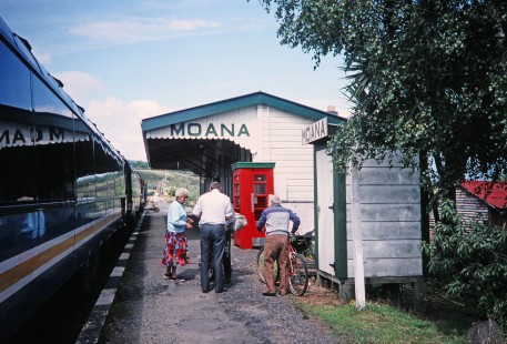 Three passengers talk with each other at Moana station next to a Trans Alpine passenger train in Moana, New Zealand, on January 17, 1994. Photograph by Fred M. Springer, © 2014, Center for Railroad Photography and Art. Springer-NZ(1)-13-31