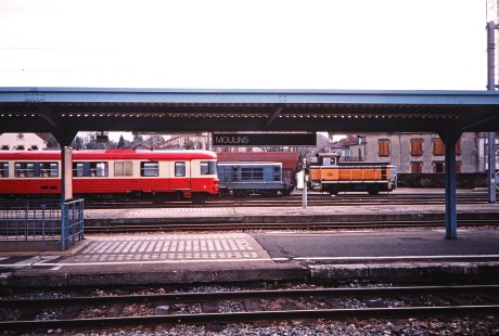 Several different train cars and locomotives loiter at a station platform in Moulins, France, on March 1, 1999. Photograph by Fred M. Springer, © 2014, Center for Railroad Photography and Art. Springer-FRA-SD&AE-C&TS(1)-02-32