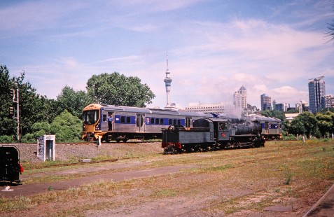 Commuter train and steam locomotive on the outskirts of Auckland, Auckland/Franklin, New Zealand, on January 3, 2004. Photograph by Fred M. Springer, © 2014, Center for Railroad Photography and Art. Springer-Canada-NZ(1)-22-32