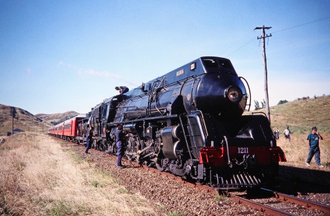 Glenbrook Vintage Railway 4-8-2 steam locomotive no. 1211 or "Gloria" with workers and passengers in Putorino, Hawke's Bay, New Zealand, on Decemeber 30, 1995. Photograph by Fred M. Springer, © 2014, Center for Railroad Photography and Art. Springer-NZ(2)-01-01