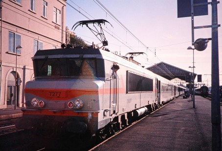 National Society of French Railways electric locomotive no. 7277 stands in the sun with a passenger train in Beziers, Languedoc-Roussillon, France, on March 2, 1999. Photograph by Fred M. Springer, © 2014, Center for Railroad Photography and Art. Springer-FRA-SD&AE-C&TS(1)-03-09