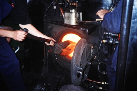 A worker tends the fire on a Weka Pass Express Railway locomotive in Waipara, Canterbury, New Zealand, on January 15, 1996. Photograph by Fred M. Springer, © 2014, Center for Railroad Photography and Art. Springer-NZ(2)-15-32