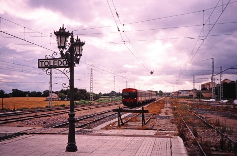 Renfe Operadora passenger train led by car no. 155C appraoches the Toledo station platform in Toledo, Spain, on July 6, 2001. Photograph by Fred M. Springer, © 2014, Center for Railroad Photography and Art. Springer-Spain-BNSF-02-10