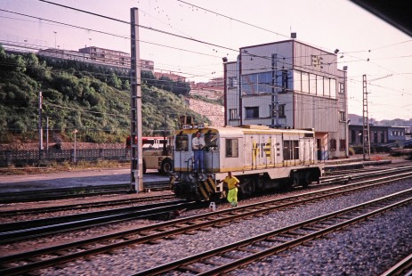 Two workers attend to a Renfe Feve diesel locomotive at a designated Renfe Feve station stop in Santander, Cantabria, Spain, on July 13, 2001. Photograph by Fred M. Springer, © 2014, Center for Railroad Photography and Art. Springer-Spain-BNSF-14-37