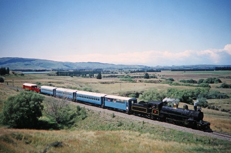 Weka Pass Railway/Trans Alpine steam locomotive no. 428 with its six-passenger train stretches across the track in Waipara, North Canterbury, New Zealand, on January 16, 1994. Photograph by Fred M. Springer, © 2014, Center for Railroad Photography and Art. Springer-NZ(1)-11-39