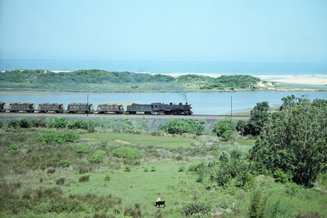 Rede Ferroviária Federal S.A. 2-10-2 steam locomotive no. 207 treks across a green and sandy coastal landscape in Imbituba, Santa Catarina, Brazil, on October 30, 1990. Photograph by Fred M. Springer, © 2014, Center for Railroad Photography and Art. Springer-PA-BR-SOAM-ME-ARG2-06-22