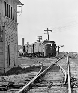 Northbound Chicago, Rock Island and Pacific Railroad freight train passes tower in Saginaw, Texas, as Atchison, Topeka and Santa Fe Railway freight train waits on horizon in August 1964. Photograph by J. Parker Lamb, © 2016, Center for Railroad Photography and Art. Lamb-02-073-10