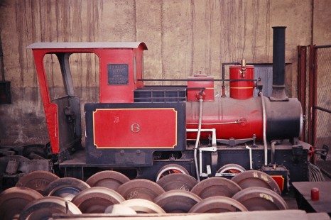 A 0-4-2 locomotive no. 6 sits with sets of train wheels at the Tubarao Shops in Tubarao, Santa Catarina, Brazil, on October 29, 1990. Photograph by Fred M. Springer, © 2014, Center for Railroad Photography and Art. Springer-PA-BR-SOAM-ME-ARG2-05-16