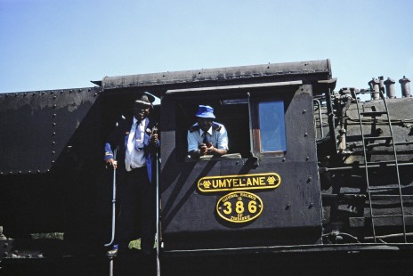 The two crew members of National Railways of Zimbabwe Garratt steam locomotive no. 386 or "Umyelane" smile at the camera in Livingstone, Southern Province, Zambia on August 8, 1991. Photograph by Fred M. Springer, © 2014, Center for Railroad Photography and Art. Springer-ZimZam(2)-Swiss-20-36