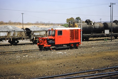 A red service car waits on the track in Hwange, Matabeleland, Zimbabwe, on August 6, 1991. Photograph by Fred M. Springer, © 2014, Center for Railroad Photography and Art. Springer-Hedjaz-ZimZam(1)-24-20