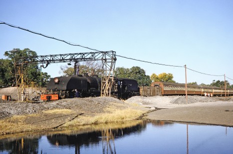 National Railways of Zimbabwe Garratt steam locomotive no. 417 receives water in Hwange, Matabeleland, Zimbabwe, on August 5, 1991. Photograph by Fred M. Springer, © 2014, Center for Railroad Photography and Art.  Springer-Hedjaz-ZimZam(1)-22-37