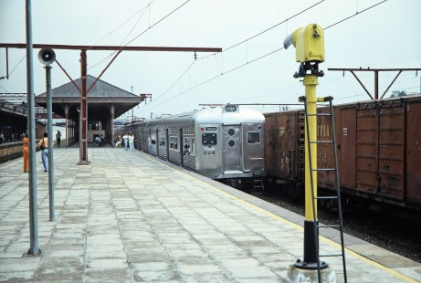 Estrada de Ferro Santos-Jundiaí (later RFFSA) electric passenger car no. 226 pulls into a covered platform with passengers waiting to board in Jundiai, Santa Catarina, Brazil, on October 31, 1990. Photograph by Fred M. Springer, © 2014, Center for Railroad Photography and Art. Springer-PA-BR-SOAM-ME-ARG2-06-09