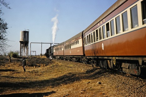 A National Railways of Zimbabwe Garratt steam locomotive heads toward a water stop near Bulawayo, Zimbabwe, on August 2, 1991. Photograph by Fred M. Springer, © 2014, Center for Railroad Photography and Art. Springer-Hedjaz-ZimZam(1)-19-10