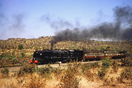 National Railways of Zimbabwe Garratt steam locomotive no. 608 pulls a passenger train along rural track in Mbalabala, Matabeleland, Zimbabwe, in August of 1991. Photograph by Fred M. Springer, © 2014, Center for Railroad Photography and Art. Springer-Hedjaz-ZimZam(1)-20-22